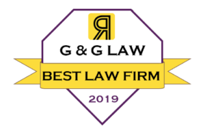 A diamond-shaped badge with a yellow ribbon that reads "G & G Law: Best Law Firm, 2019."